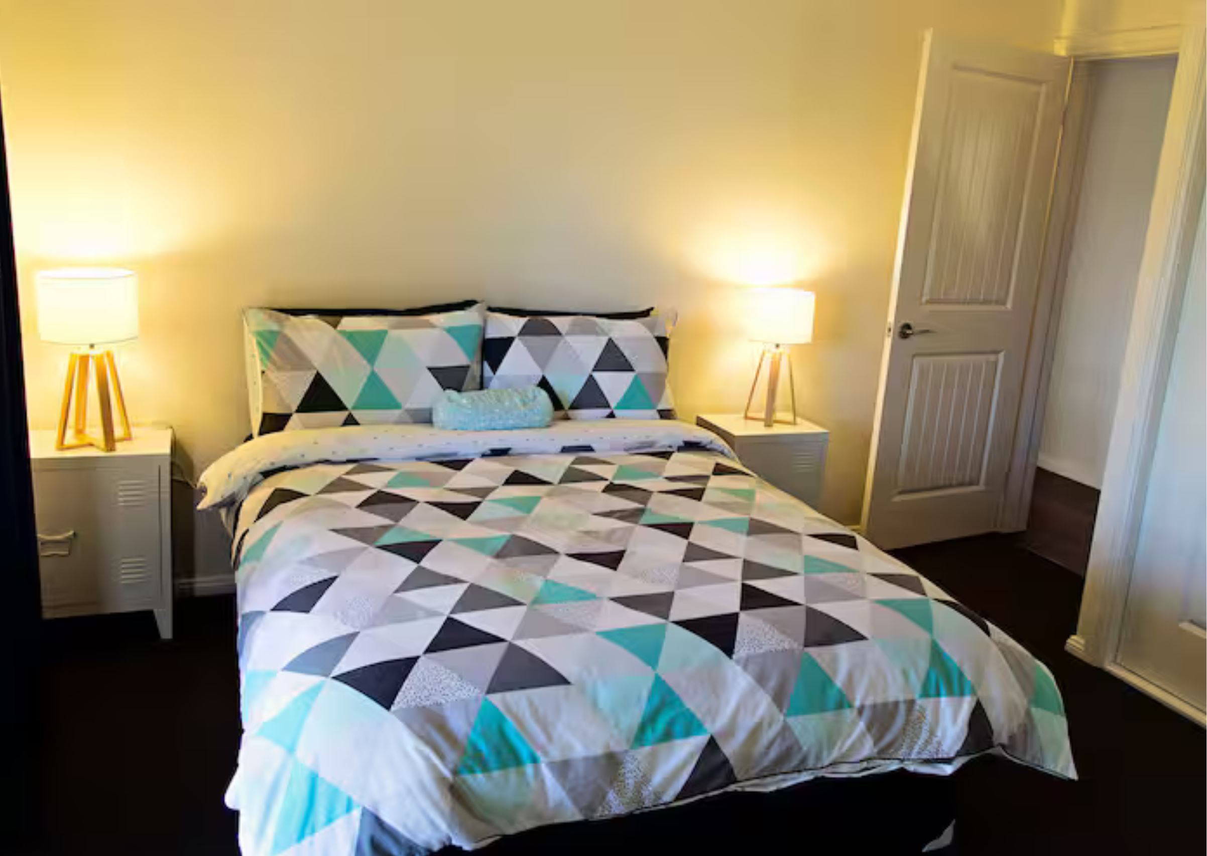 A comfortable queen bedroom with views of the surrounding bushland.