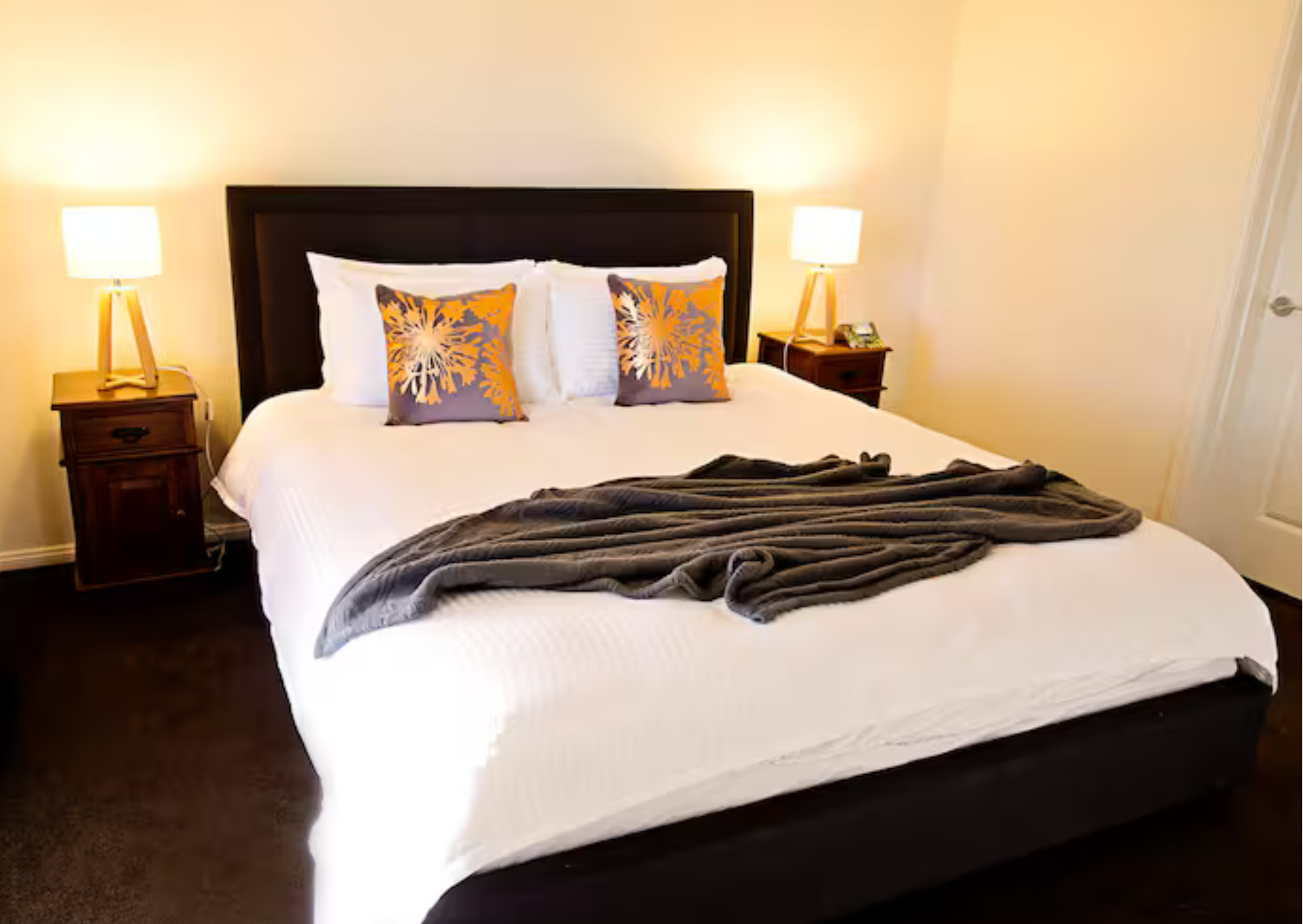 The spacious main bathroom with a modern vanity, separate glass shower, and a deep soaking bathtub.